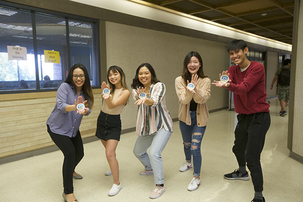 Photo of five students holding Elevate AAPI stickers